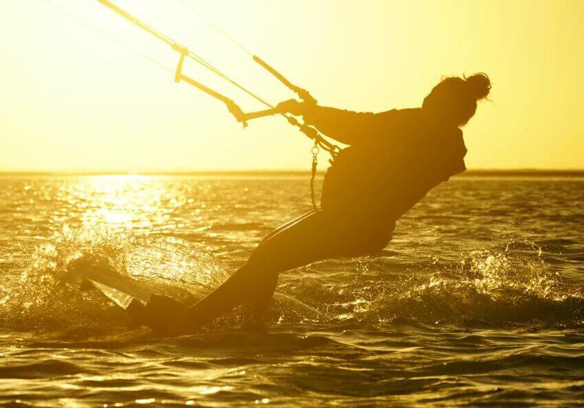 Kitesurfeur naviguant sous le soleil du lagon pour echapper a l hiver europeen