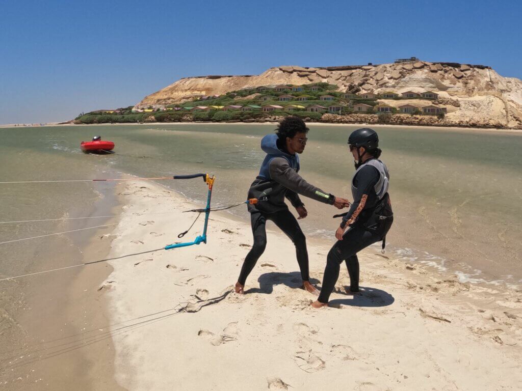 Débutant en train d'apprendre le kitesurf a dakhla avec un moniteur sur le lagon calme